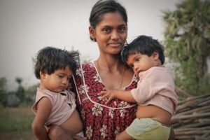 Indian woman holding two children