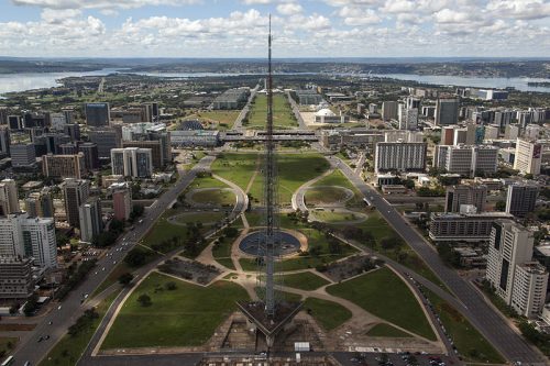 Brasilia aerial view of a park in the middle of a city with mountains and water in the background