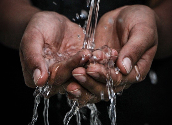 hands under flowing water
