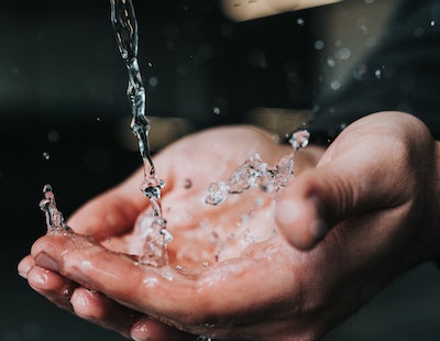 water splashing on hands close up